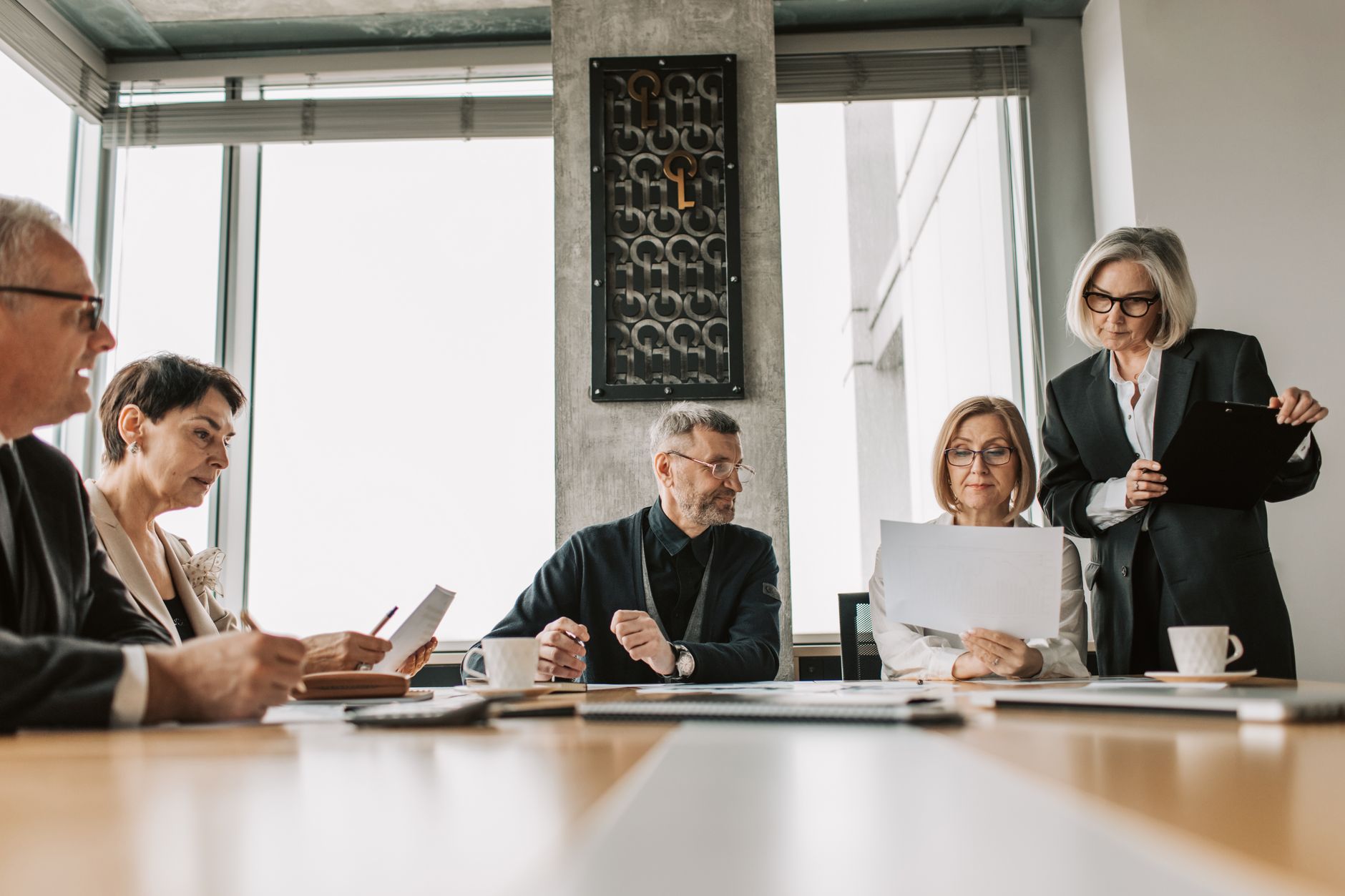 Close up on premium boardroom dynamic with conscious presence